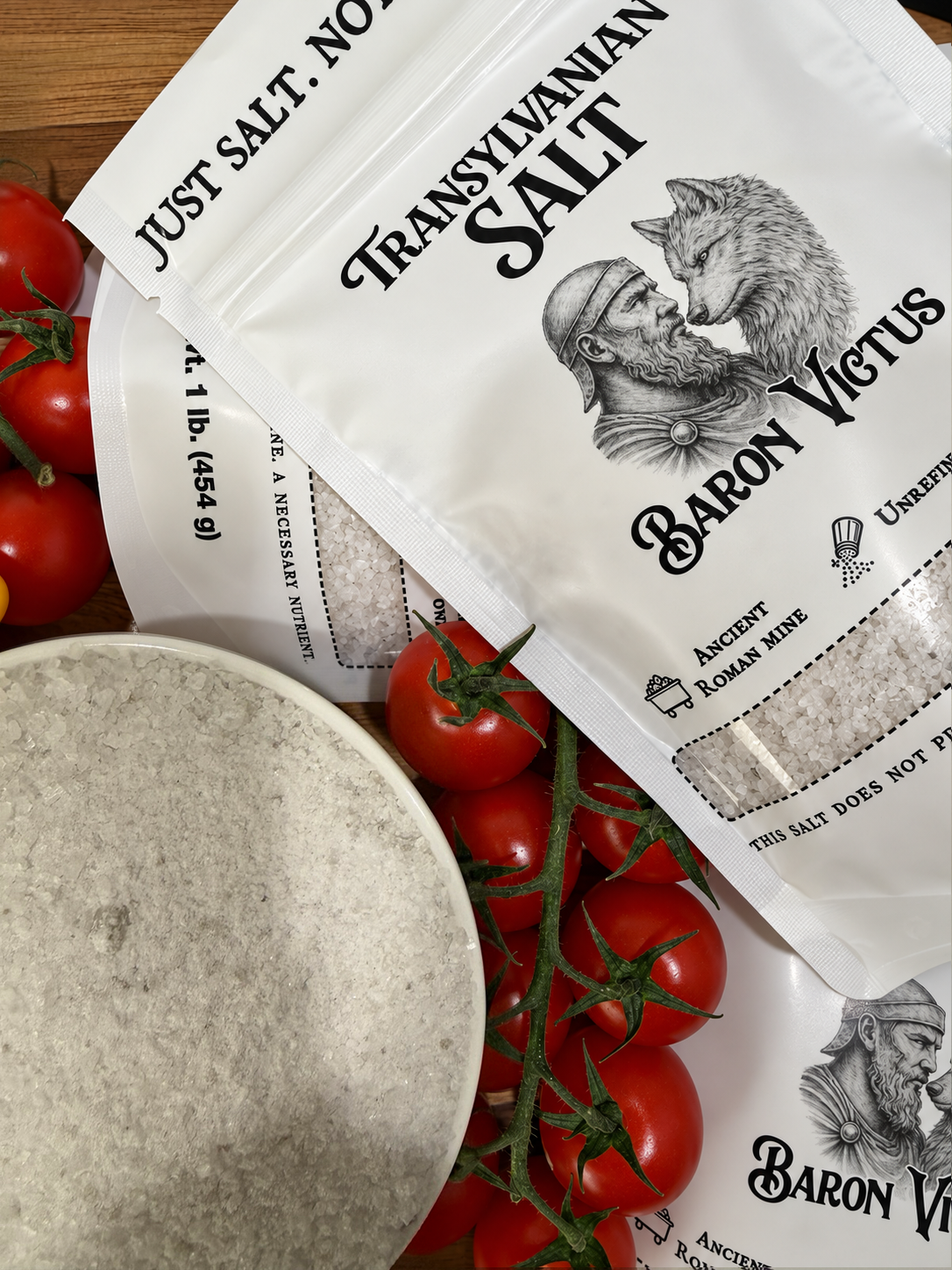Baron Victus salt pouches, a bowl of salt and tomatoes.