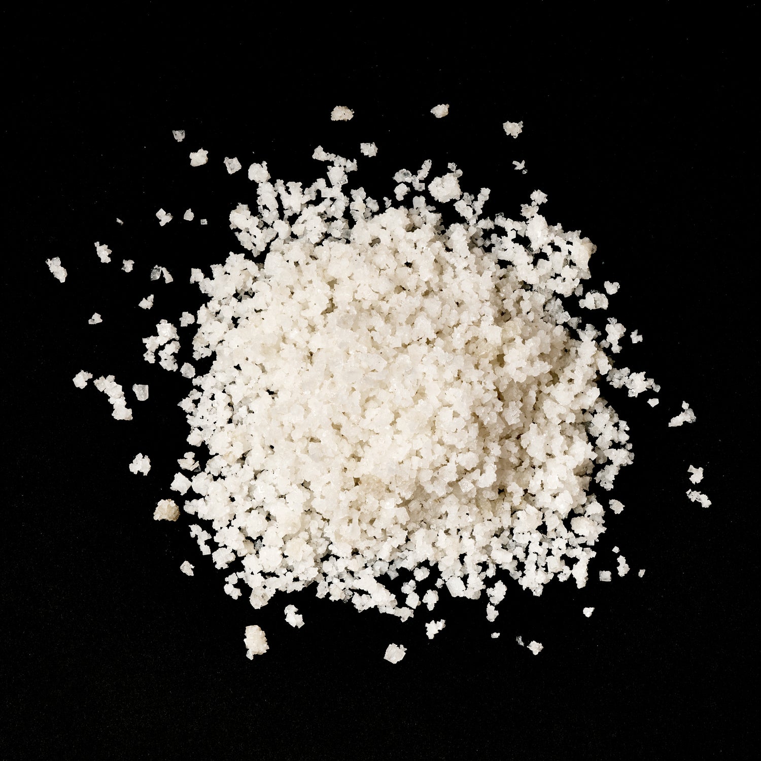 A mound of Light Grey Celtic salt crystals against a black background.