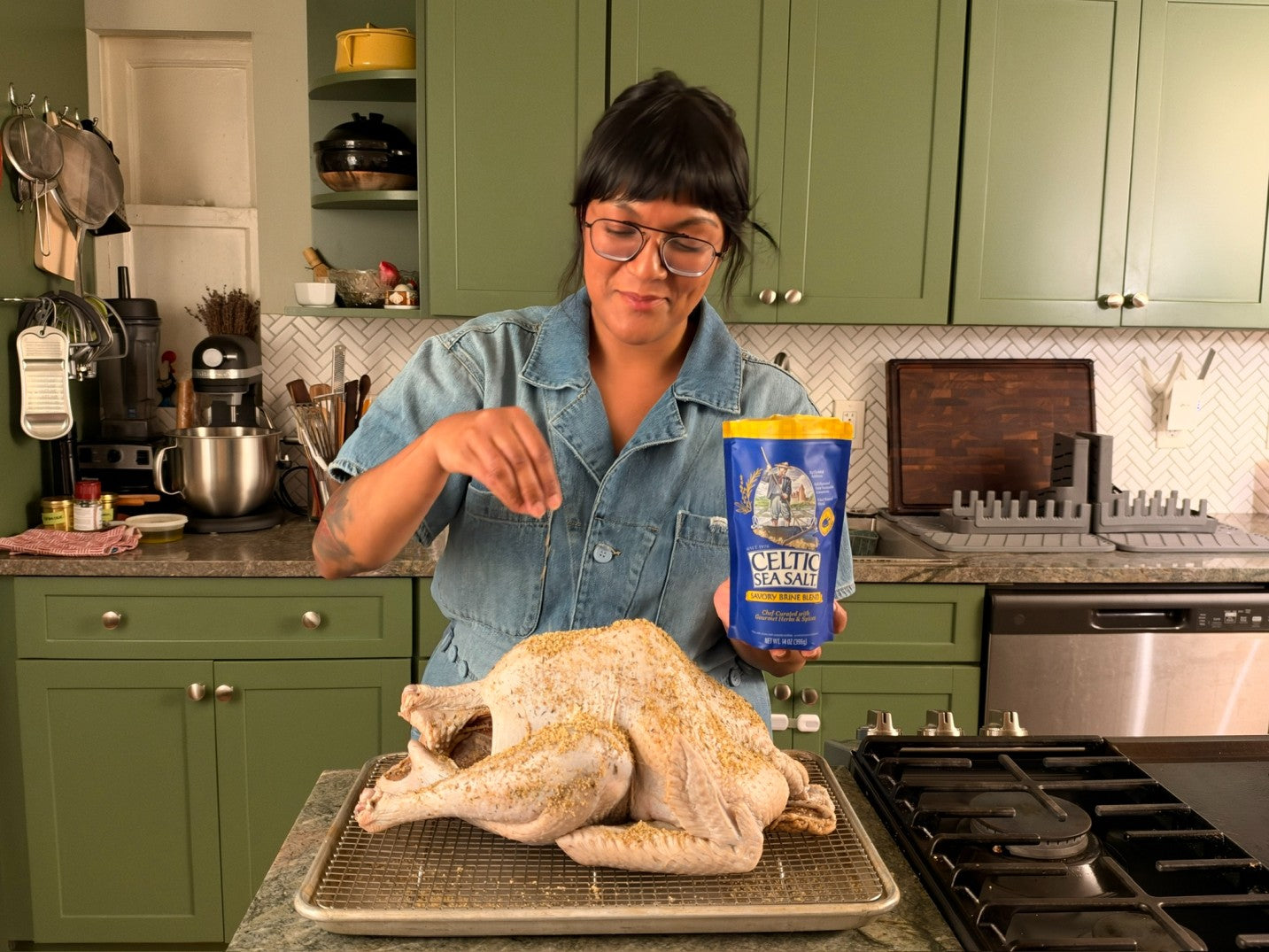 Sohla El-Waylly sprinkling the blend over a turkey on a rack.