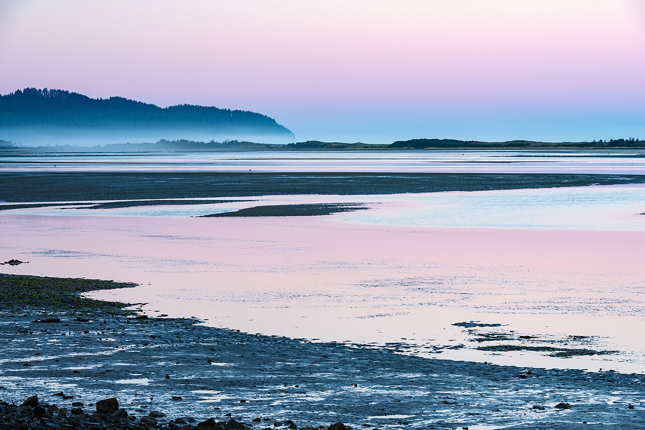 Sunrise at Netarts Bay. Surrounding landscape of Netarts Bay; the Jacobsen production facility is not shown.